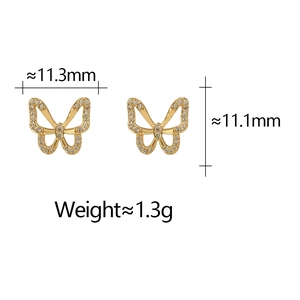 Detail shot of hollow butterfly earrings in gold finish with white rhinestones
