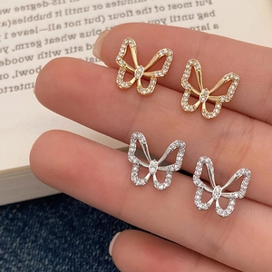 Elegant hollow butterfly stud earrings in gold and silver set with sparkling zircons