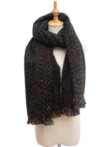 Detailed close-up of heavy knit black tweed scarf with colorful flecks and fringe