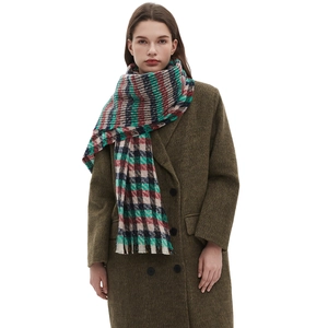 Classic colorful plaid knit scarf with fringe trim paired with a green winter coat