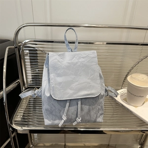 Retro light blue vintage backpack with wrinkled texture and drawstring flap closure