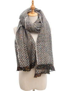 Close-up of herringbone knit scarf with multicolor marl yarn and fringed edges