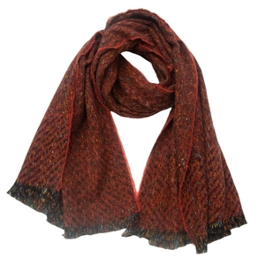 Macro detail of mixed color twill woven scarf with fringe edges and warm texture