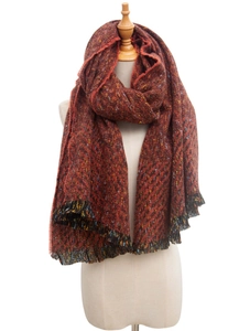 Detail of chunky knit scarf in rust brown with multi-color flecks and fringe trim