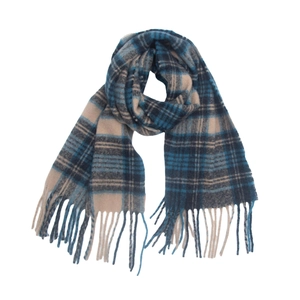 Close-up of thick plaid scarf with blue and beige grid patterns and tassel fringe details