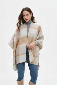 Detail of soft cashmere-feel plaid shawl wrap with split sides and fine edge stitching
