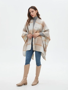Detail of checkered cashmere-feel shawl with hand-stitched edges and split hem design