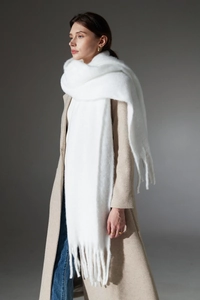 Detailed view of thick white textured scarf with chunky fringe and plush mohair texture