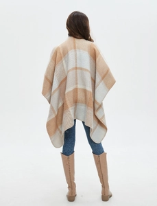 Detail view of plaid cashmere-like shawl showing split hem and high-quality fabric texture