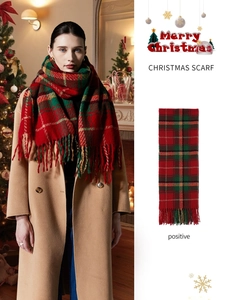 Detail of red and green Christmas plaid scarf with long tassels and soft knit texture