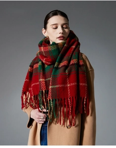 Detail of red and green plaid scarf featuring thick wool-like texture and fringed edges