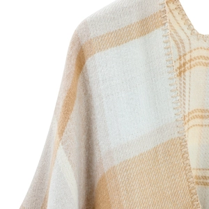 Detail of checkered cashmere-like shawl featuring soft beige fabric and blanket stitch edges