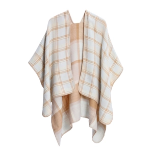 Detail of soft cashmere-like knit fabric with classic plaid pattern and hemmed edges
