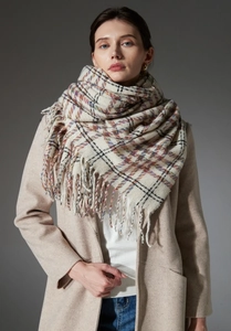 Close-up of thick plaid shawl scarf with tassels and colorful checkered weave details