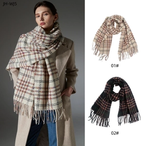 Detailed close-up of thick checkered scarves with tassels in light and dark color options