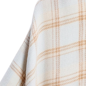 Macro detail of beige and brown plaid cashmere-like shawl fabric with soft textures