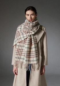 Detailed view of checkered tassel shawl scarf on model with autumn winter coat style