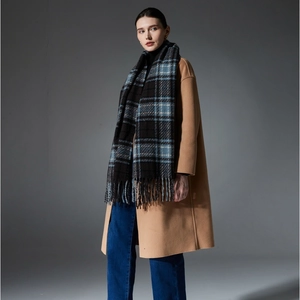 Women's autumn camel wool coat paired with a classic blue plaid fringe scarf accessory