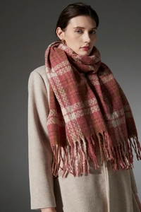 Close-up of winter scarf with pink and brown plaid pattern and soft fringe tassels