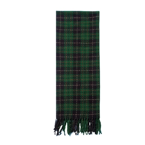 Detail shot of green and black plaid scarf with red stripes and fringe tassels