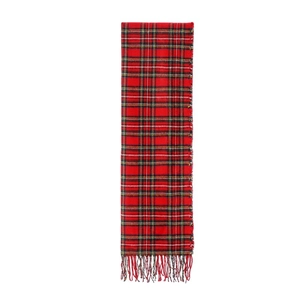 Detailed close-up of red plaid scarf fabric texture and fringe tassel ornaments