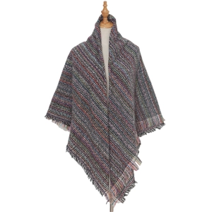 Close-up of multicolored plaid shawl featuring complex weave and rainbow fringe details
