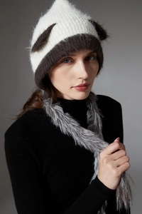 Detail view of cat ear knit hat featuring fluffy faux fur texture and contrast trim