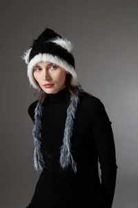 Detailed close-up of winter knit hat with plush cat ears and long faux fur tassels on model