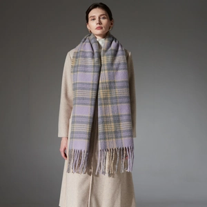 Classic lilac and beige plaid scarf with tassels styled on a premium cashmere coat