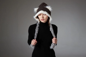 Detail view of winter knit hat featuring faux fur cat ears and matching long earflap scarves