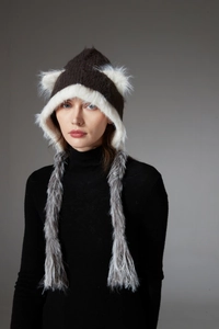 Detailed view of the fuzzy faux fur trim and braided tassels on the cat ear knit hat