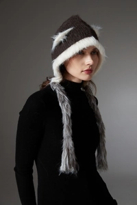 Detailed view of winter knit cat ear hat featuring plush faux fur and long grey tassels