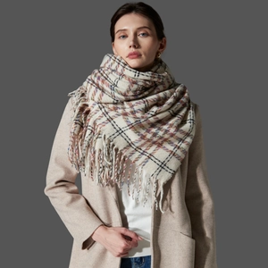 Classic houndstooth plaid scarf with tassels, styled on a warm beige autumn winter coat