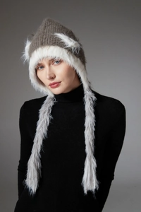 Close-up of knit winter hat with cat ears and long faux fur braids for outdoor warmth