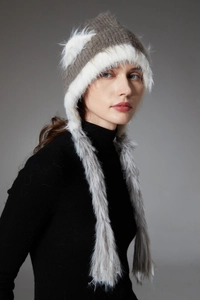 Detail of winter knit cat ear hat with thick faux fur lining and long earflaps