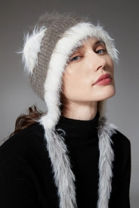 Detailed side view of winter knit hat with cat ears and soft faux fur lining trim