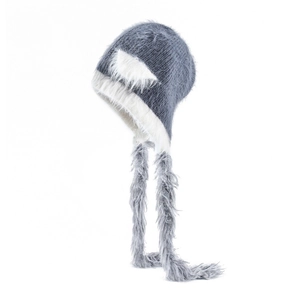 Detailed knit texture of grey winter hat with white faux fur cat ears and long earflaps