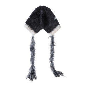 Close-up of fluffy black and white winter hat with cat ears and long braided tassels