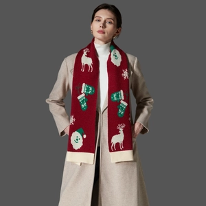 Red Christmas knit scarf with white reindeer and snowflake patterns on a model