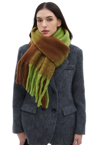 Detail of chunky checkered scarf with green and brown tassels on grey wool coat