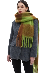 Detail of chunky plaid scarf with green and brown checkered pattern and thick fringes