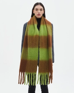 Close-up of thick green and brown plaid scarf with fringe detail on a grey coat