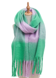 Detail of green and lavender checkered knit scarf with thick tassels on a mannequin