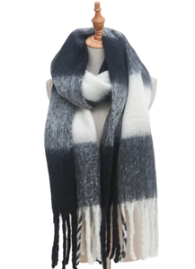 Detail of soft mohair-like knit scarf with large plaid blocks and thick long tassels