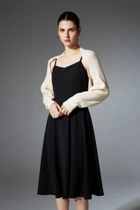 Detail of beige knitted shawl paired with black slip dress showing fine knit texture