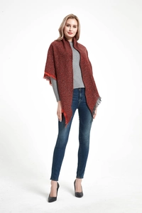 Deep reddish-brown knitted shawl with fringe details shown on a model for a warm winter look