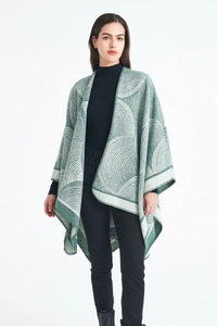 Détail du châle poncho en laine mélangée avec jacquard géométrique vert et bords cousus