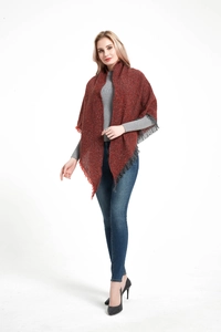 Detail of dark reddish-brown knit shawl with textured fabric and grey fringe trim