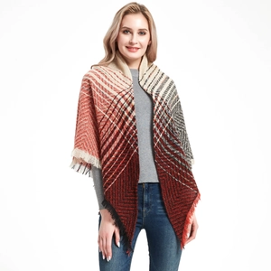 Detail of red and black geometric knit texture with fine fringe edges on a winter shawl