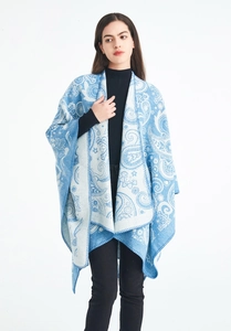 Close-up of blue and white paisley jacquard wool shawl with fine stitching details